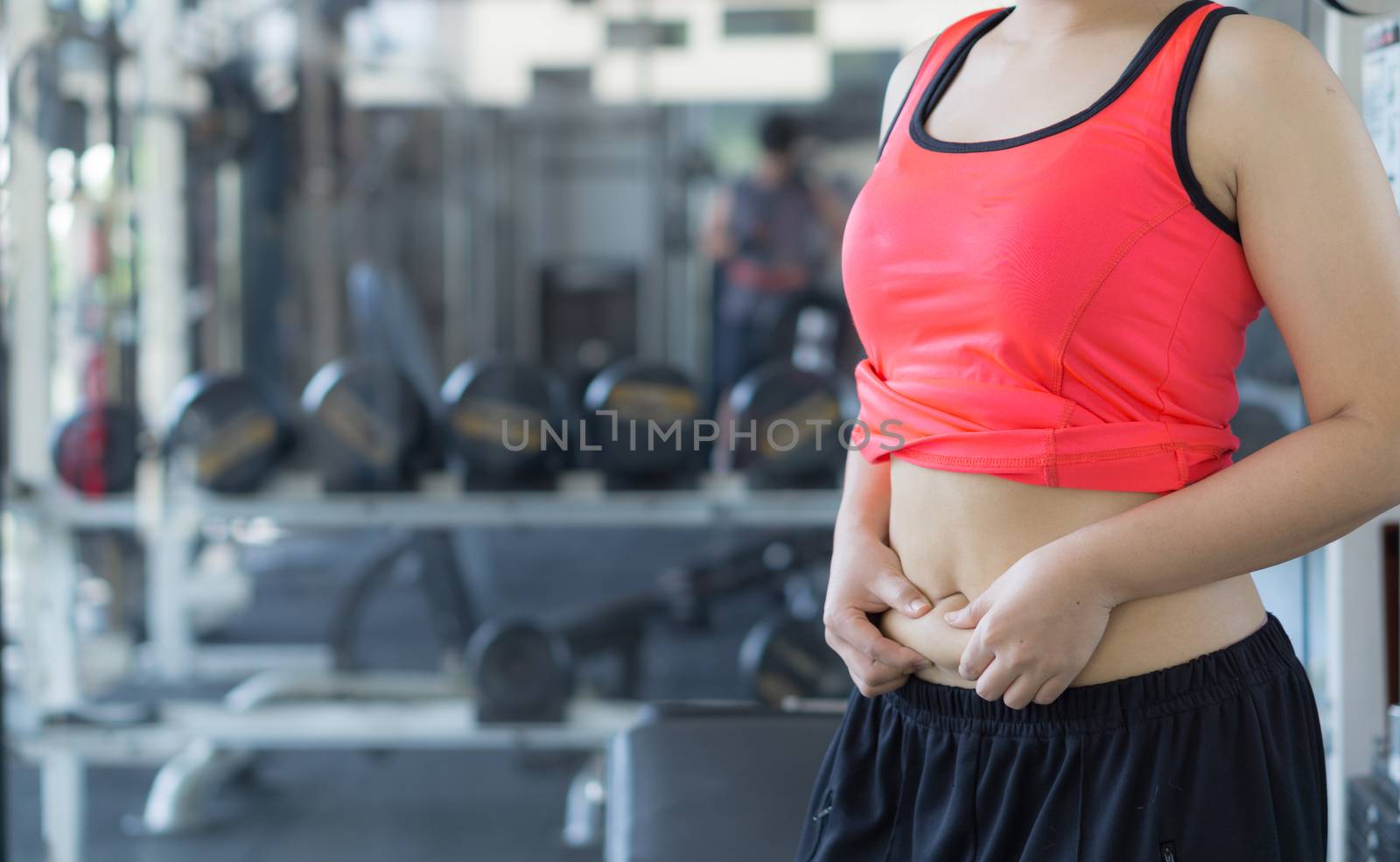 Close up woman holding excessive fat belly. Woman overweight abdomen. Woman diet lifestyle concept reduce belly and shape up healthy stomach muscle. Weight loss, slim body, healthy lifestyle concept.