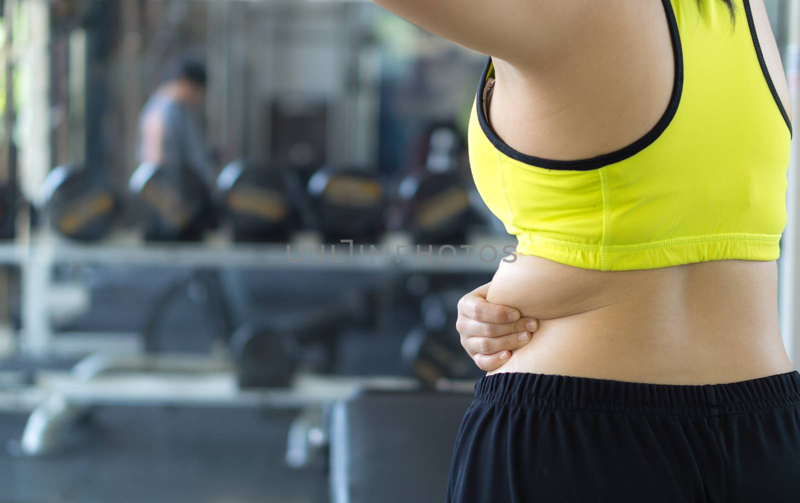 Close up woman holding excessive fat lower back. Woman overweight abdomen. Woman diet lifestyle concept reduce belly and shape up healthy stomach muscle. Weight loss, slim body, healthy concept.