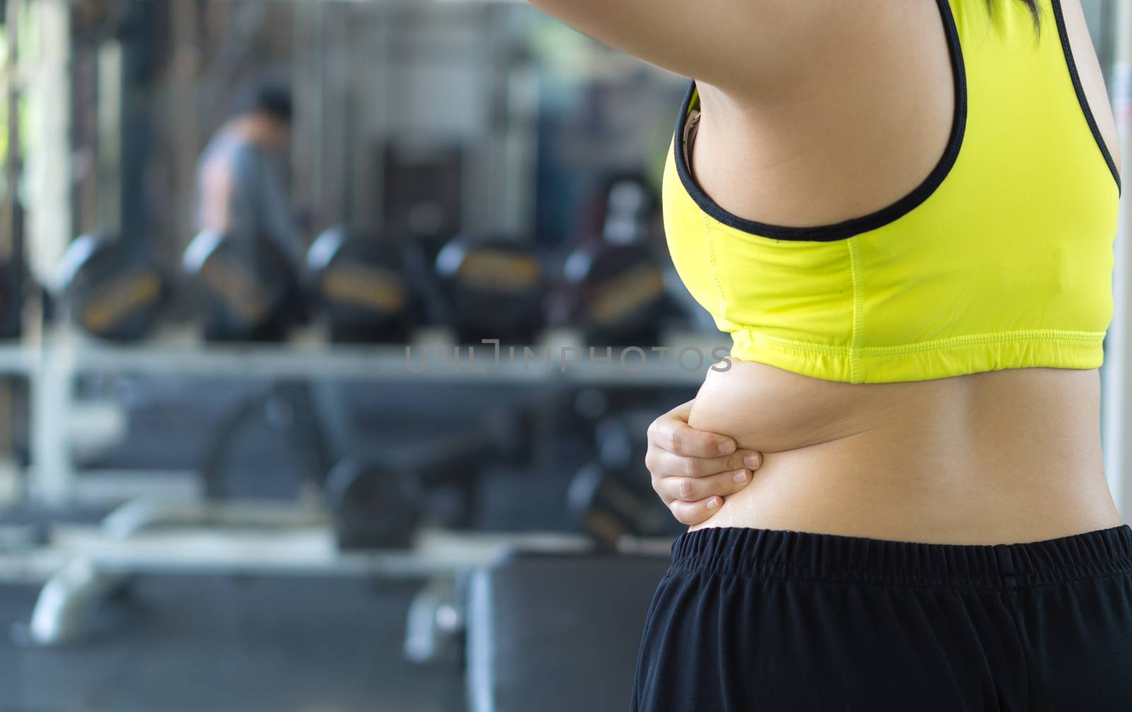 Close up woman holding excessive fat lower back. Woman overweigh by mikesaran