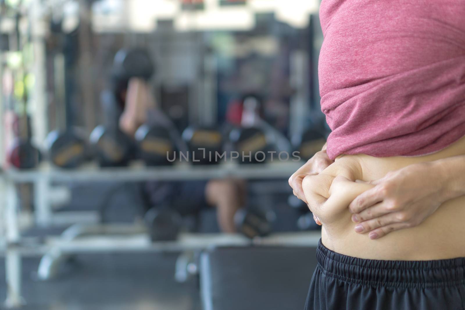 Close up man holding excessive fat belly. Man overweight abdomen. Man diet lifestyle concept reduce belly and shape up healthy stomach muscle. Weight loss, slim body, healthy lifestyle concept.