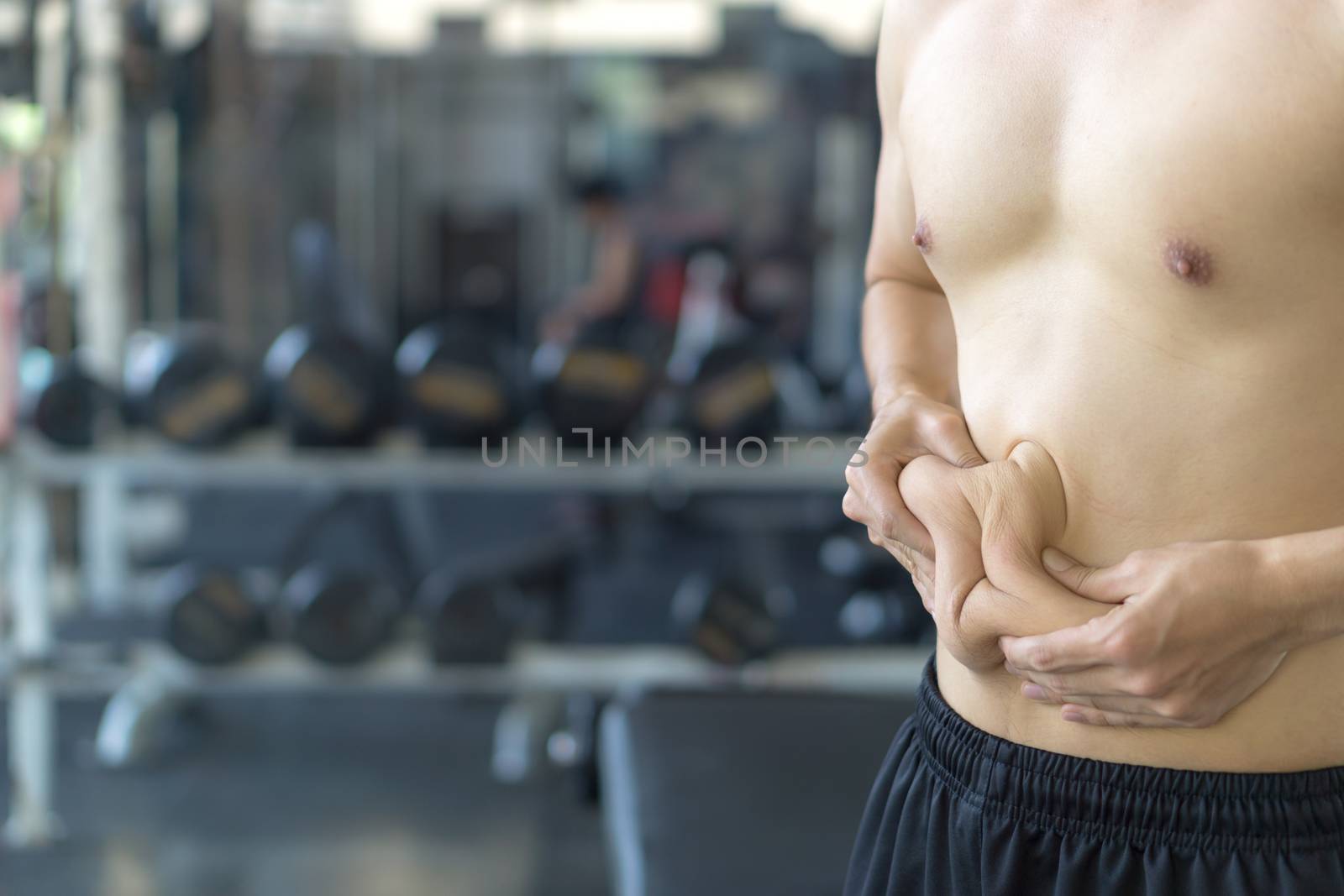 Close up man holding excessive fat belly. Man overweight abdomen by mikesaran