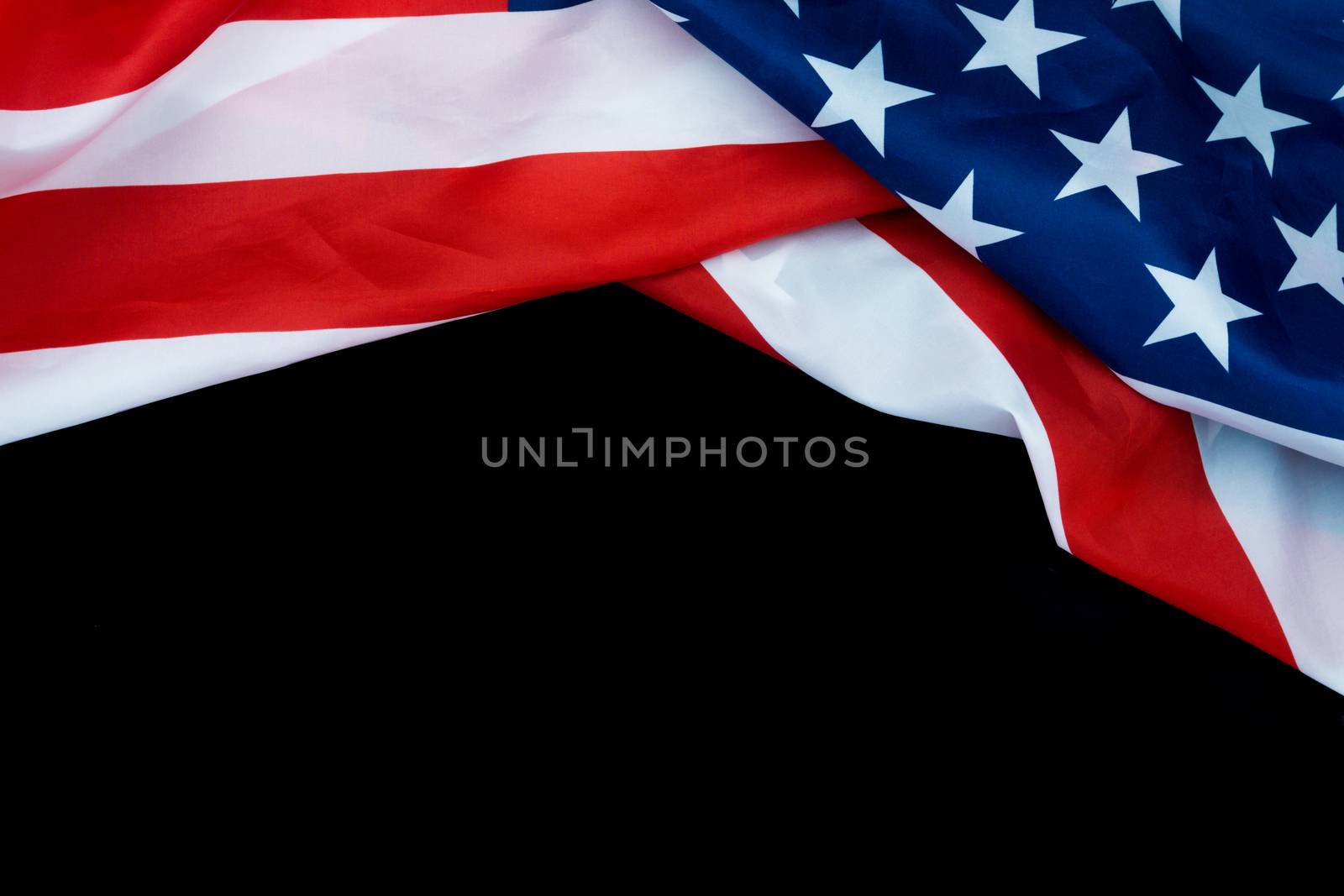 US American flag on black background. For USA Memorial day, Veterans day, Labor day, or 4th of July celebration. Top view, copy space for text.