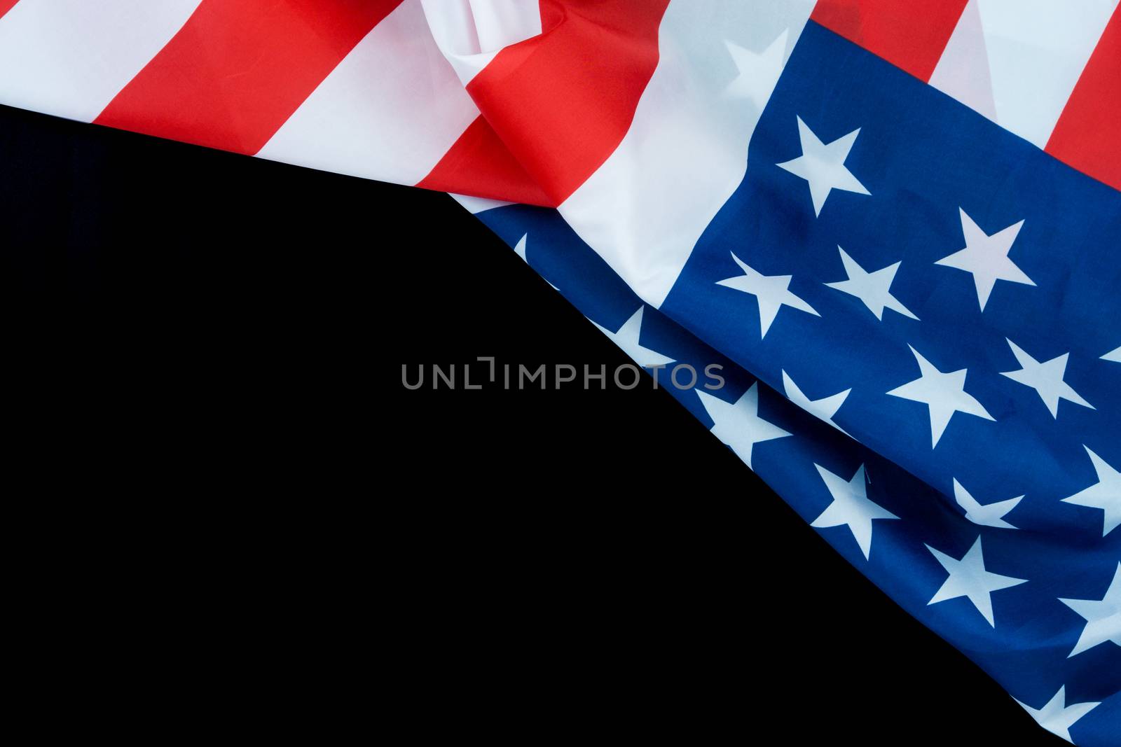 US American flag on black background. For USA Memorial day, Veterans day, Labor day, or 4th of July celebration. Top view, copy space for text.