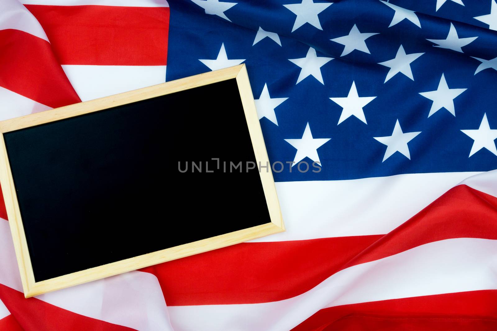 Blackboard on US American flag For USA Memorial day, Veterans day, Labor day, or 4th of July celebration. Top view, copy space for text.