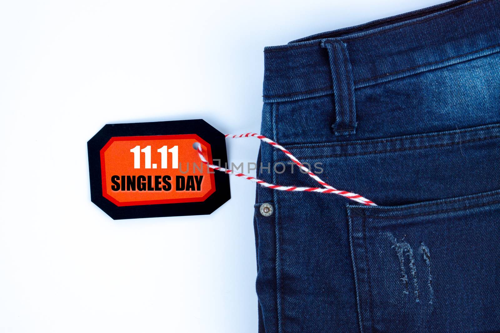 Online shopping of China, The jeans and shopping tag on a white background with copy space for text. 11.11 single's day sale concept