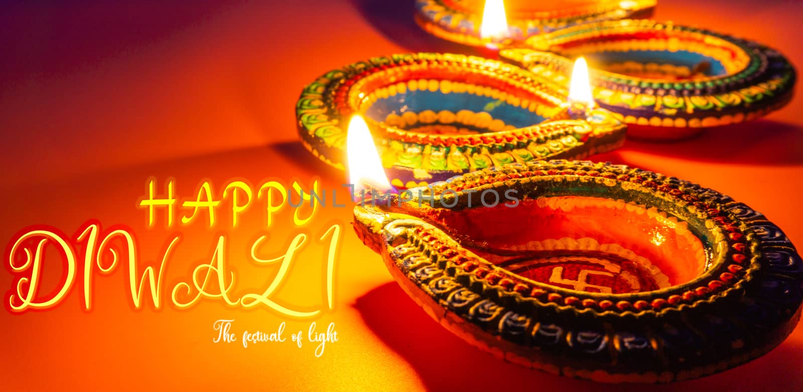 Indian festival Diwali, Diya oil lamps lit on colorful rangoli. Hindu traditional. Happy Deepavali. Copy space for text.