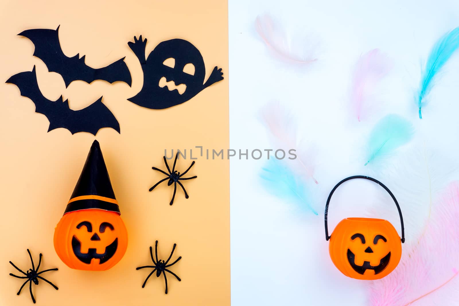 Top view of Halloween decoration, jack o lantern, ghost, bat and spider on yellow and white background with copy space for text. halloween concept.