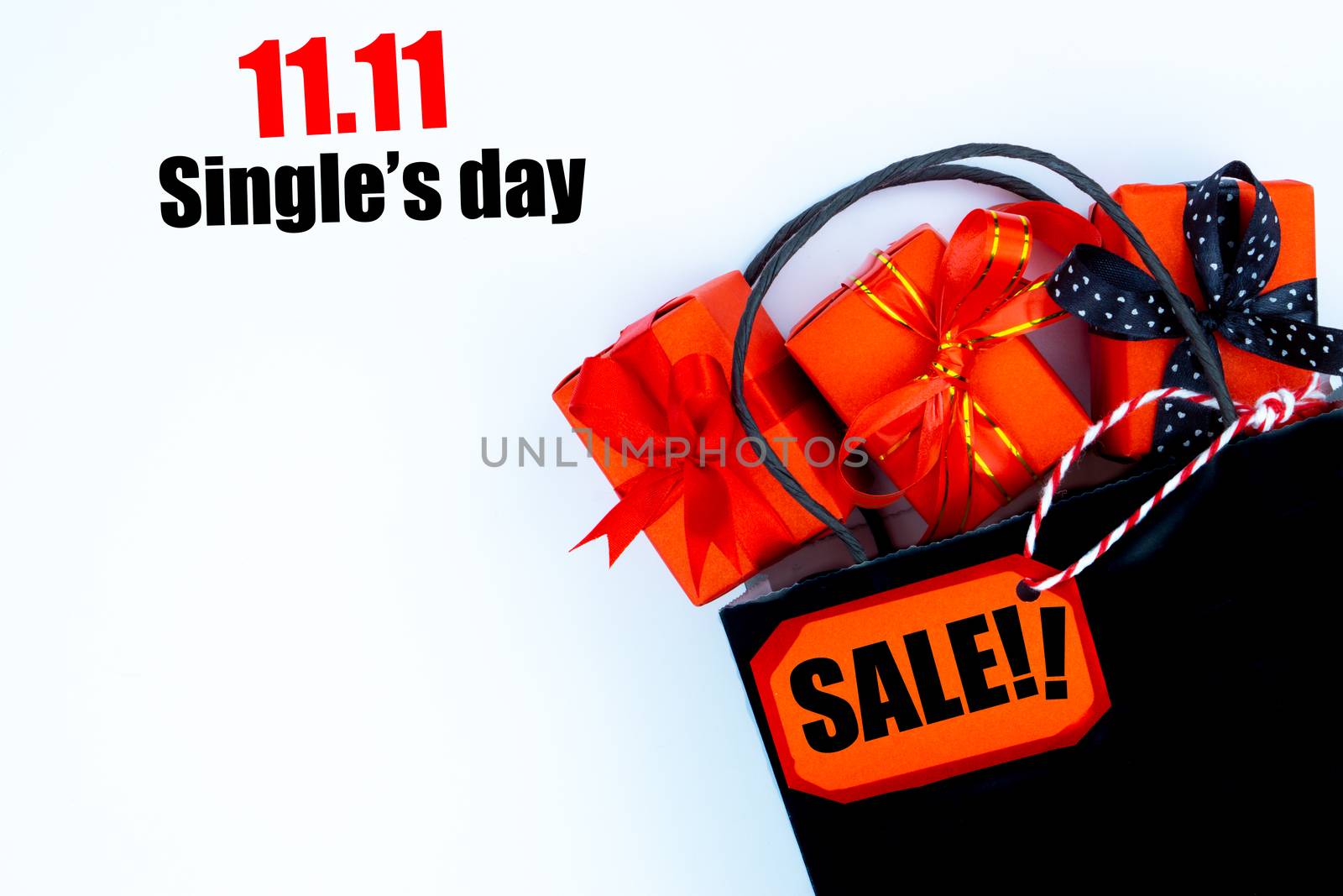 The shopping bag and Christmas boxes with red ribbon on a white background with copy space for text.Online shopping of China, 11.11 single's day sale concept