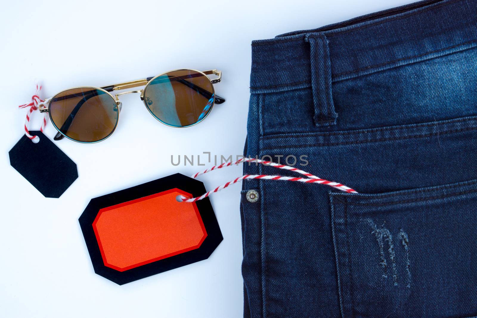 Online shopping of China, The jeans and sunglasses and shopping tag on a white background with copy space for text. 11.11 single's day sale concept