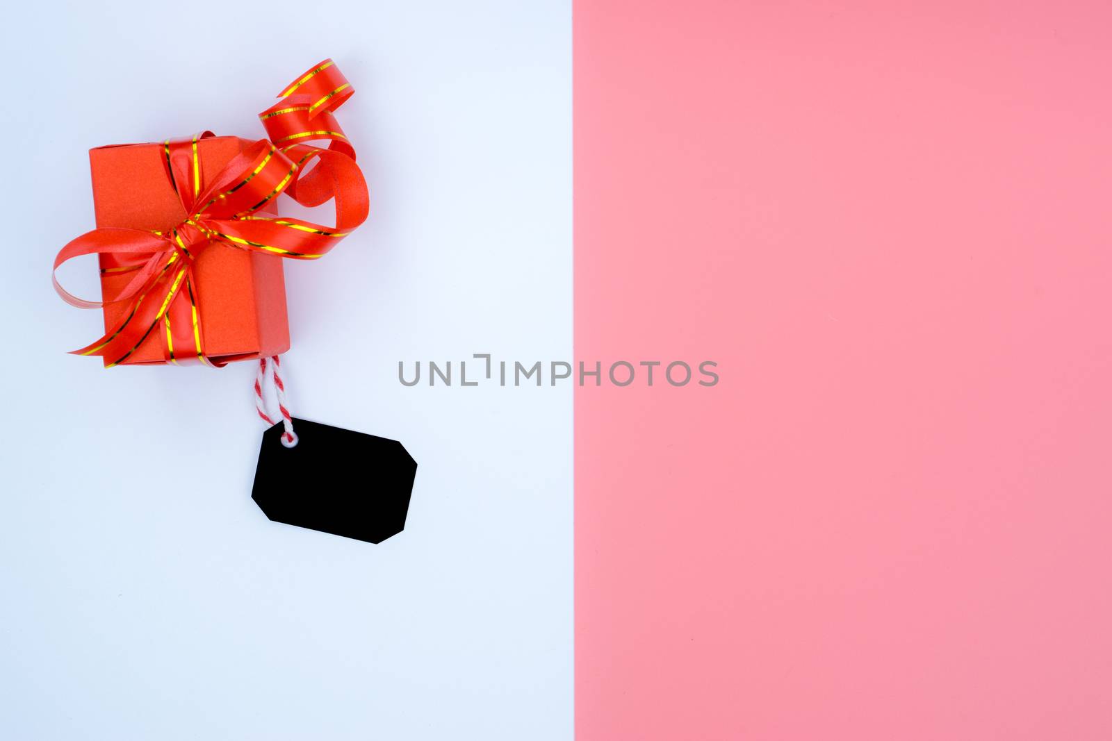 Online shopping of China, The Christmas boxes with red ribbon and shopping tag on a white and pink background with copy space for text. 11.11 single's day sale concept