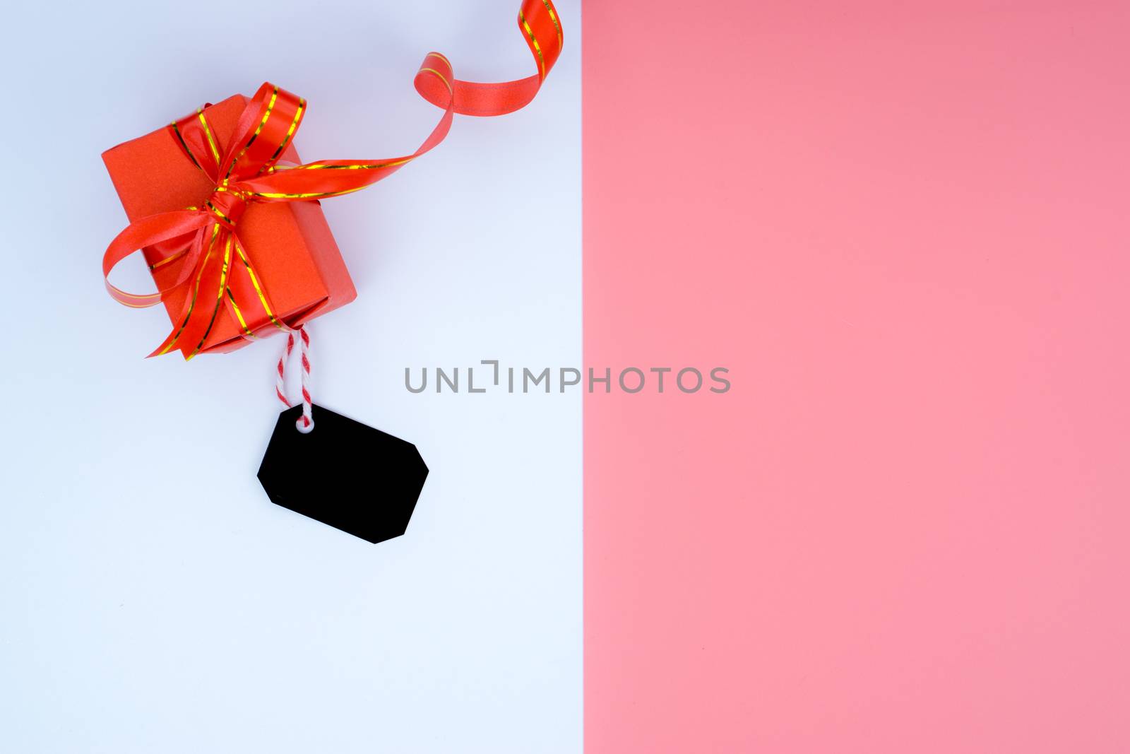 Online shopping of China, The Christmas boxes with red ribbon and shopping tag on a white and pink background with copy space for text. 11.11 single's day sale concept