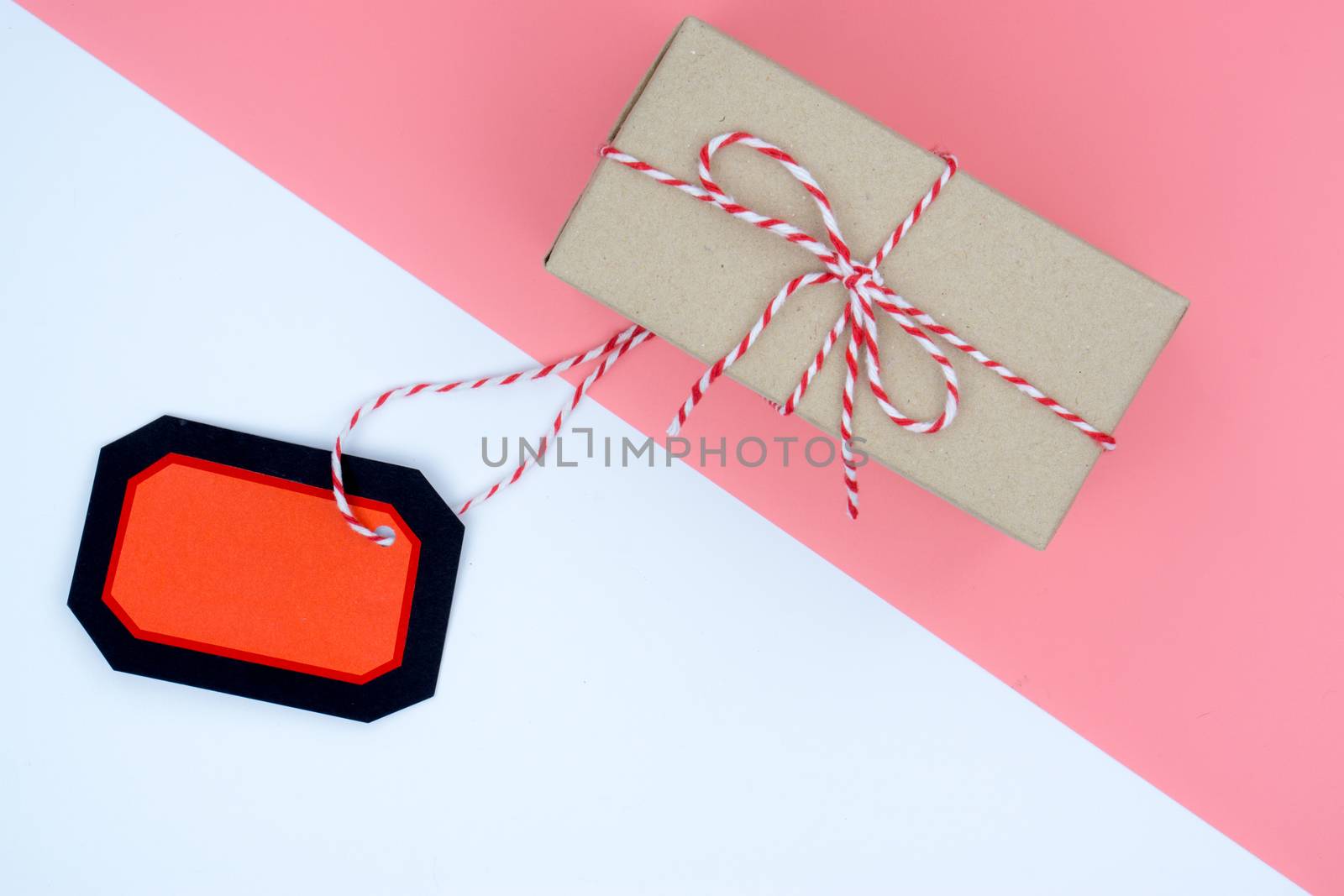 Online shopping of China, The shopping boxes with red rope and shopping tag on a white and pink background with copy space for text. 11.11 single's day sale concept