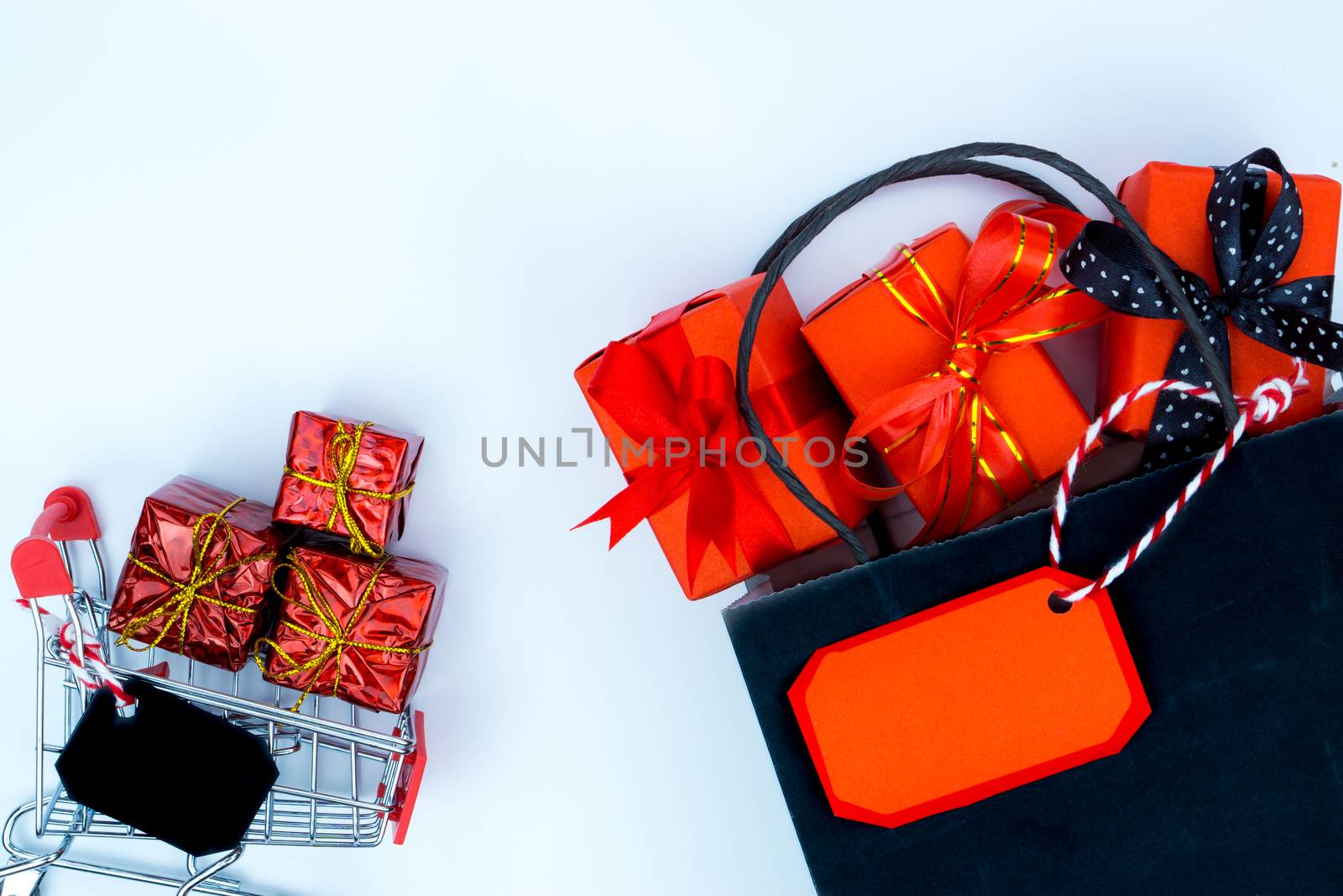 Online shopping of China, The shopping cart and Christmas boxes with red ribbon on a white background with copy space for text. 11.11 single's day sale concept