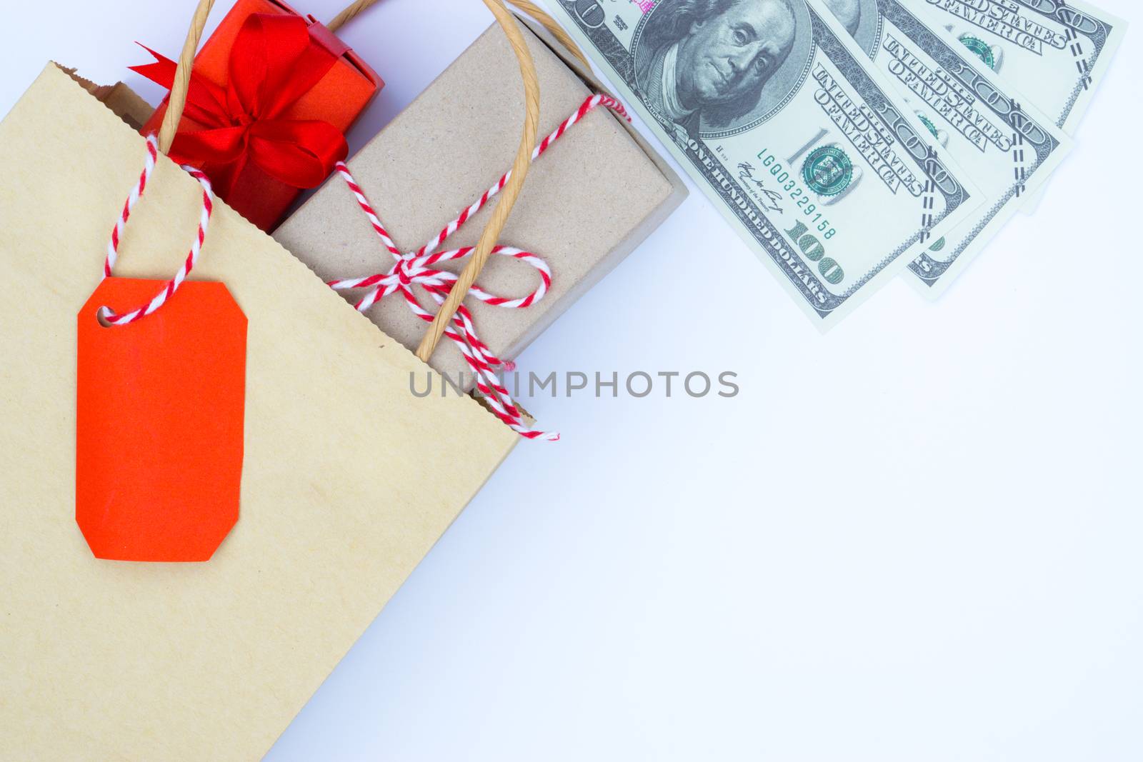 Online shopping of China, The shopping bag and Christmas boxes with red ribbon and banknote on a white background with copy space for text. 11.11 single's day sale concept