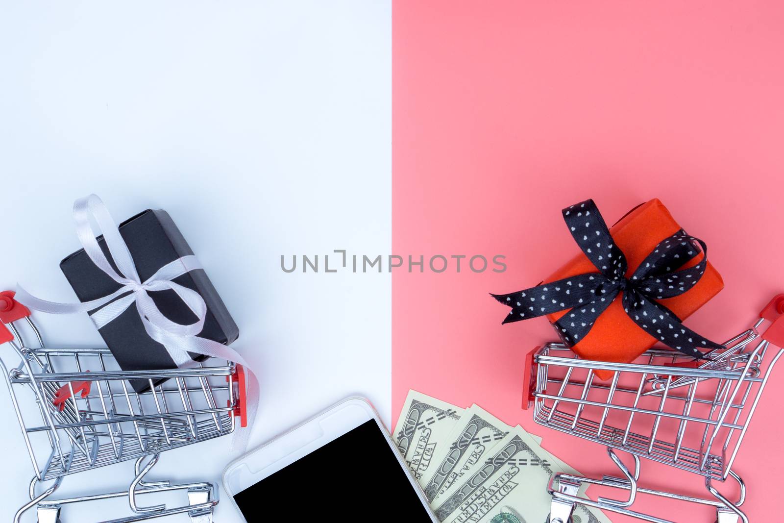 Online shopping of China, The shopping cart and Christmas boxes with black ribbon and smartphone and banknote on a white background with copy space for text. 11.11 single's day sale concept