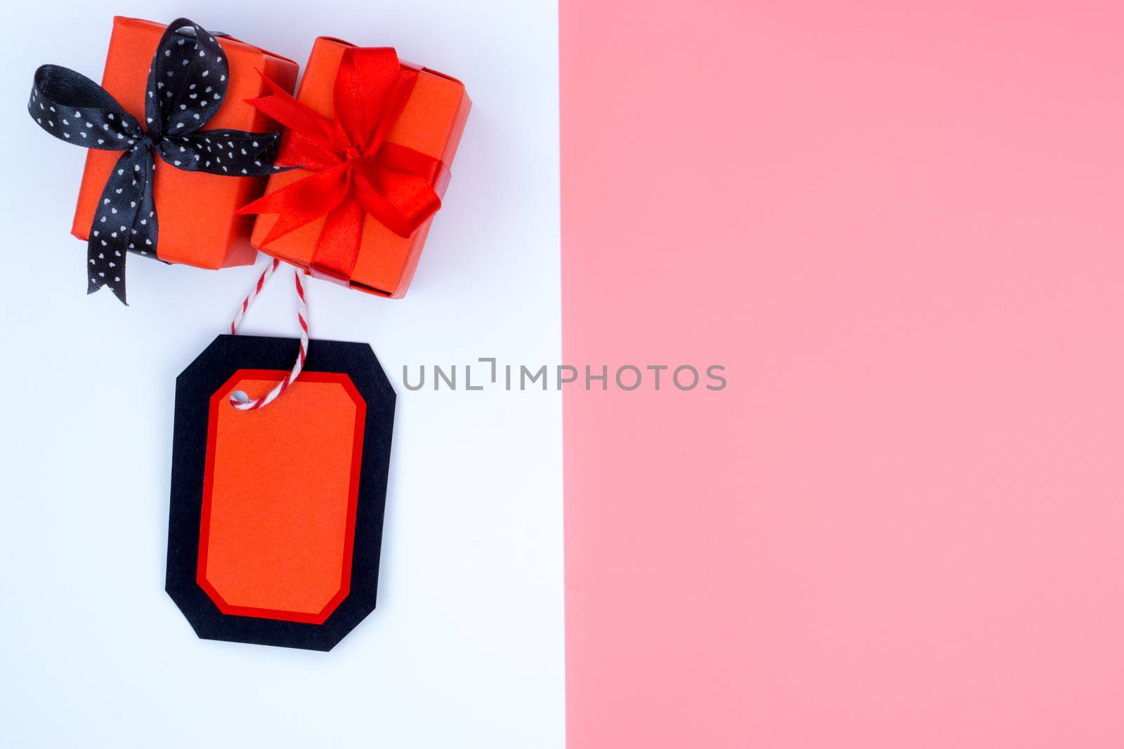 Online shopping of China, The Christmas boxes with red ribbon and shopping tag on a white and pink background with copy space for text. 11.11 single's day sale concept