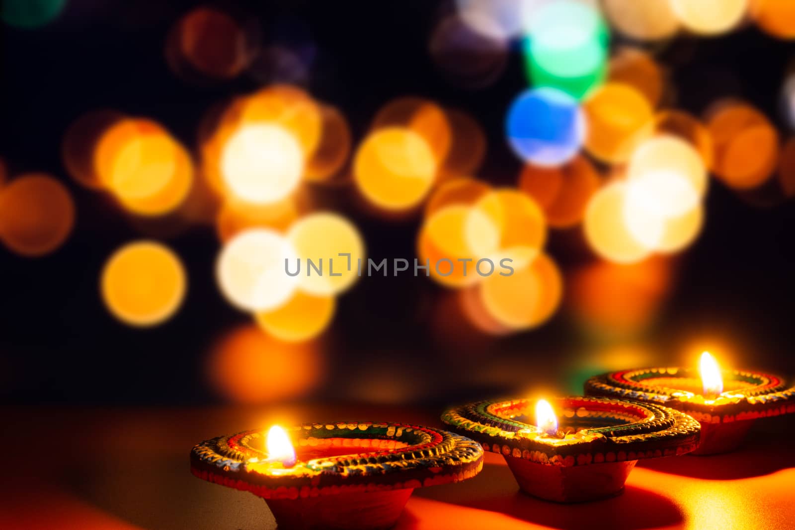 Indian festival Diwali, Diya oil lamps lit on colorful rangoli. Hindu traditional. Happy Deepavali. Copy space for text.