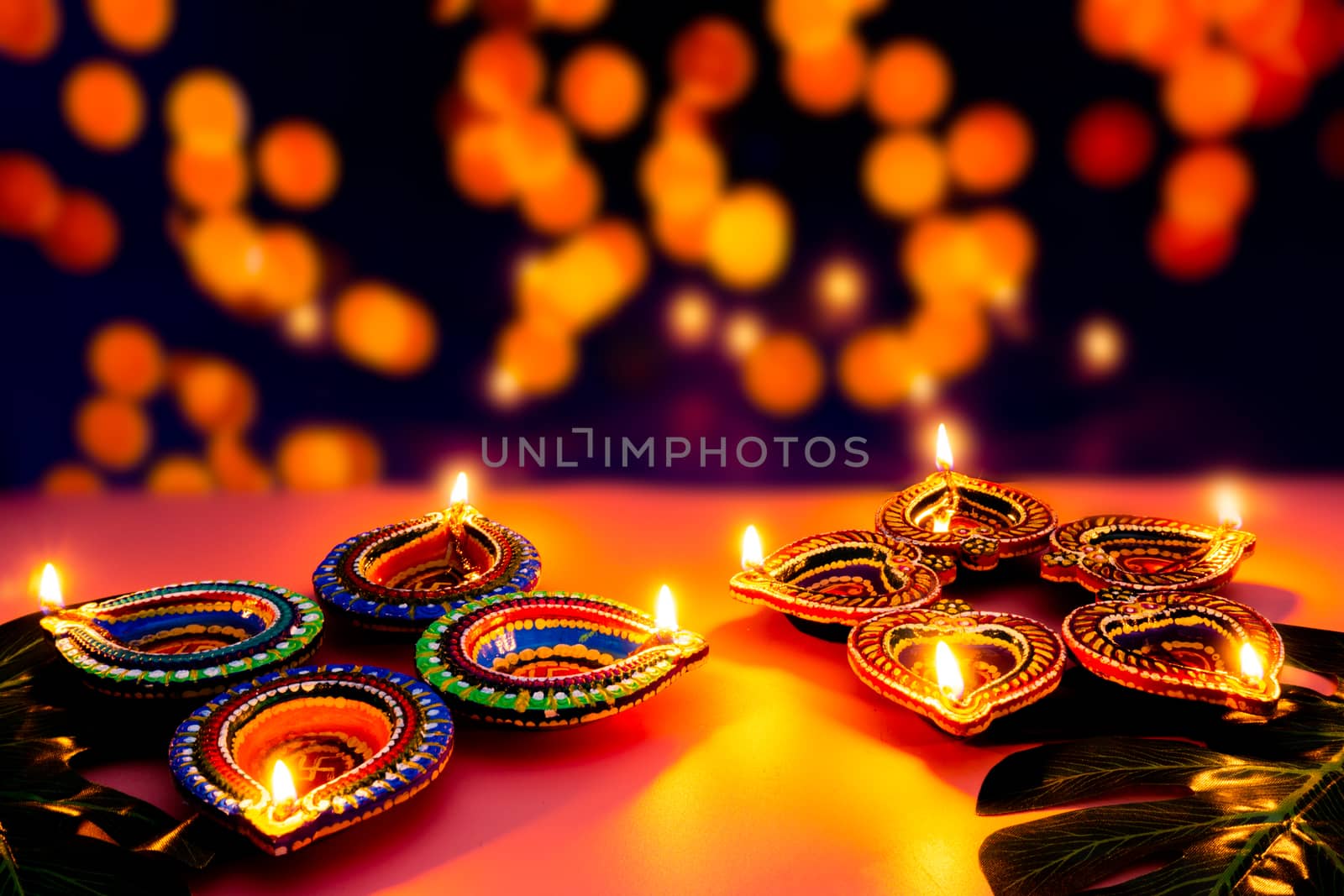 Indian festival Diwali, Diya oil lamps lit on colorful rangoli. Hindu traditional. Happy Deepavali. Copy space for text.