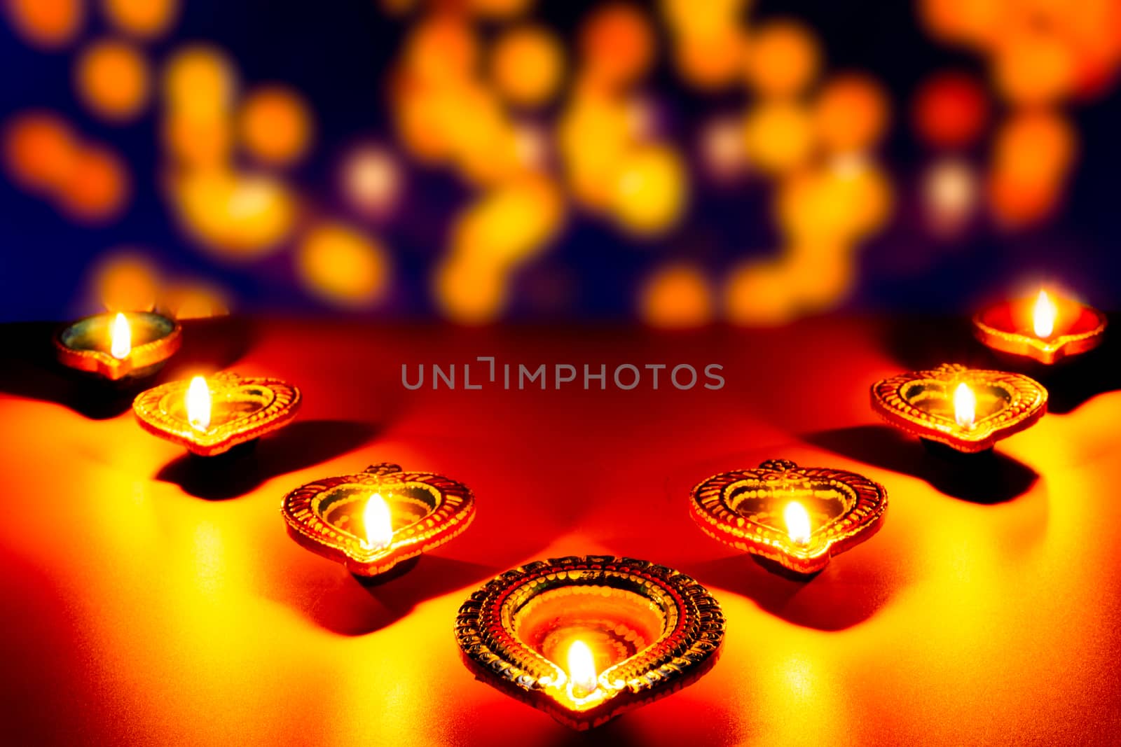 Indian festival Diwali, Diya oil lamps lit on colorful rangoli. Hindu traditional. Happy Deepavali. Copy space for text.