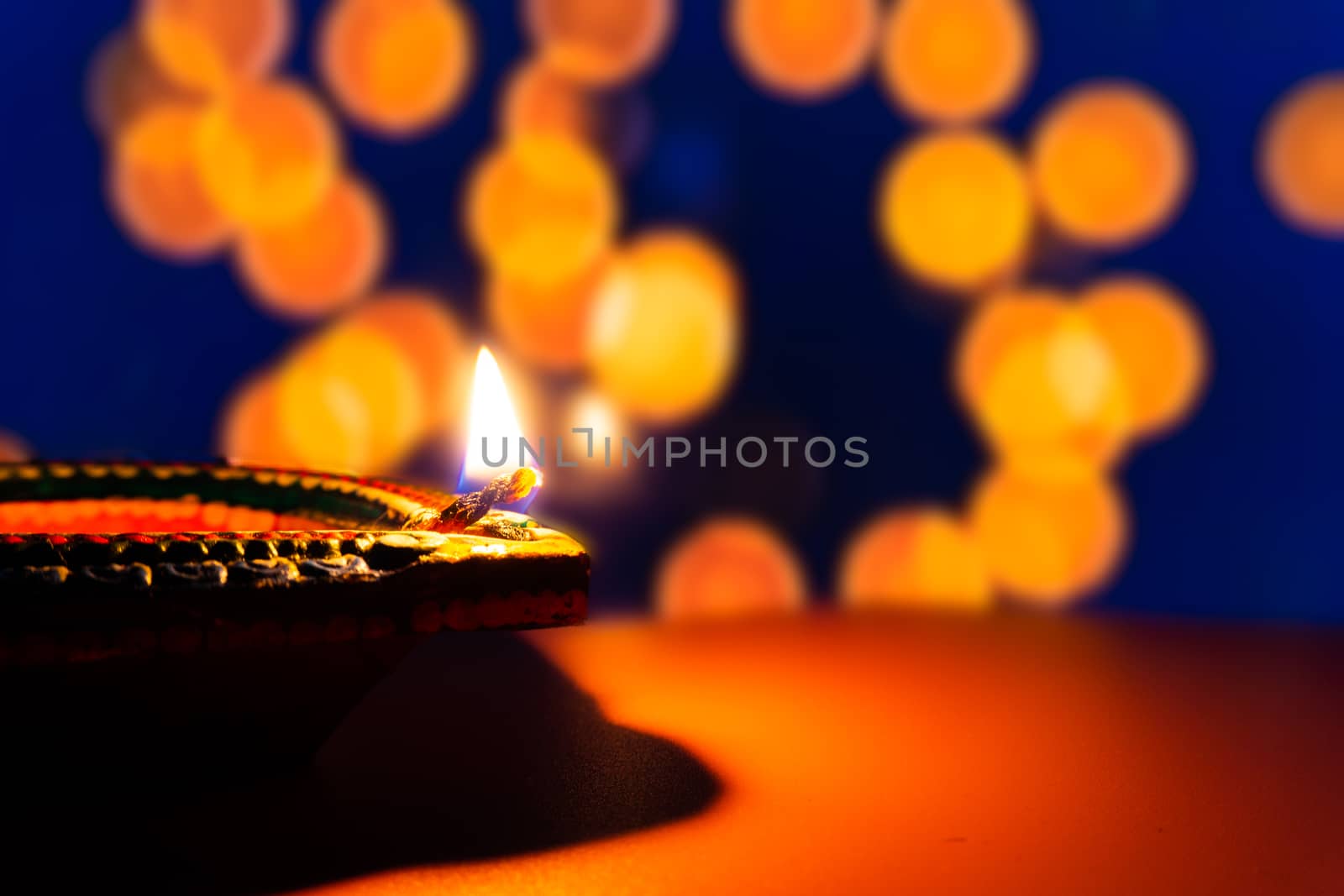 Indian festival Diwali, Diya oil lamps lit on colorful rangoli. Hindu traditional. Happy Deepavali. Copy space for text.