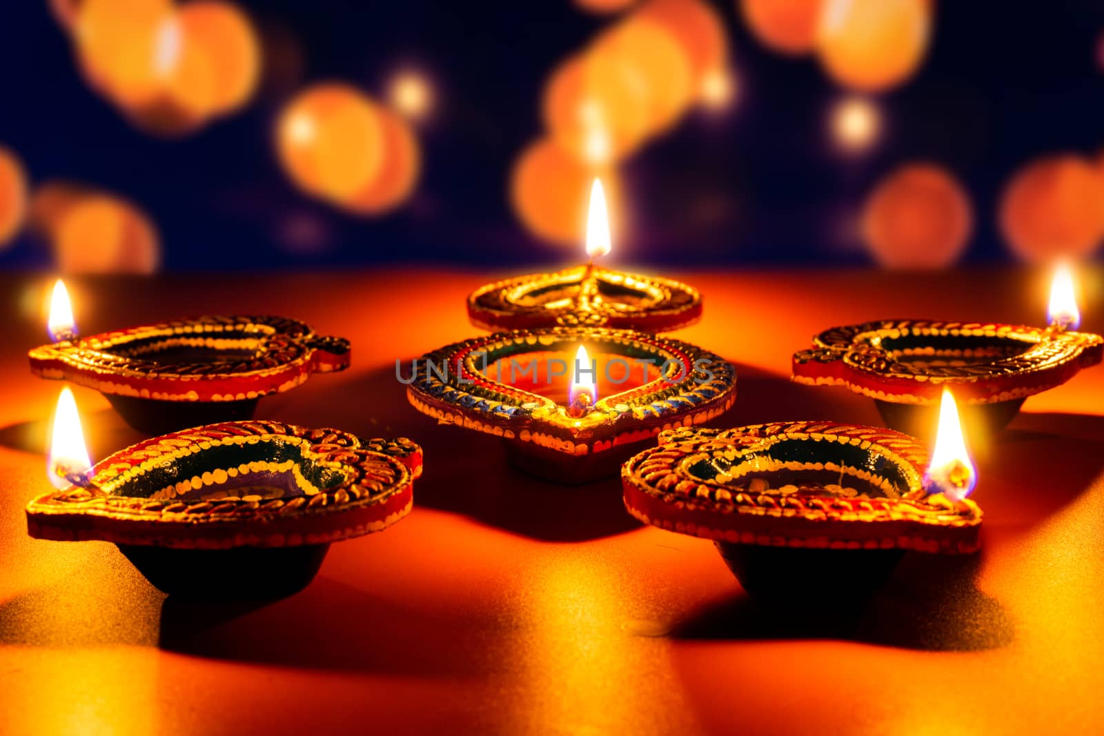 Indian festival Diwali, Diya oil lamps lit on colorful rangoli. Hindu traditional. Happy Deepavali. Copy space for text.