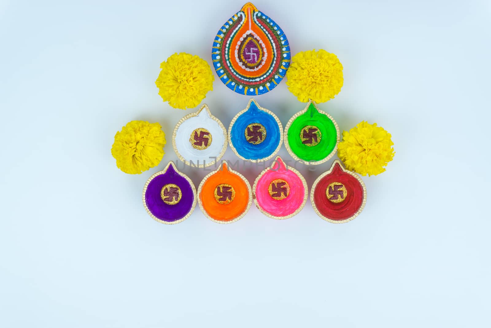 Indian festival Diwali, Diya oil lamps lit on colorful rangoli. Hindu traditional. Happy Deepavali. Copy space for text.