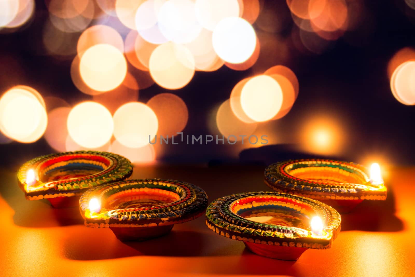 Indian festival Diwali, Diya oil lamps lit on colorful rangoli. Hindu traditional. Happy Deepavali. Copy space for text.