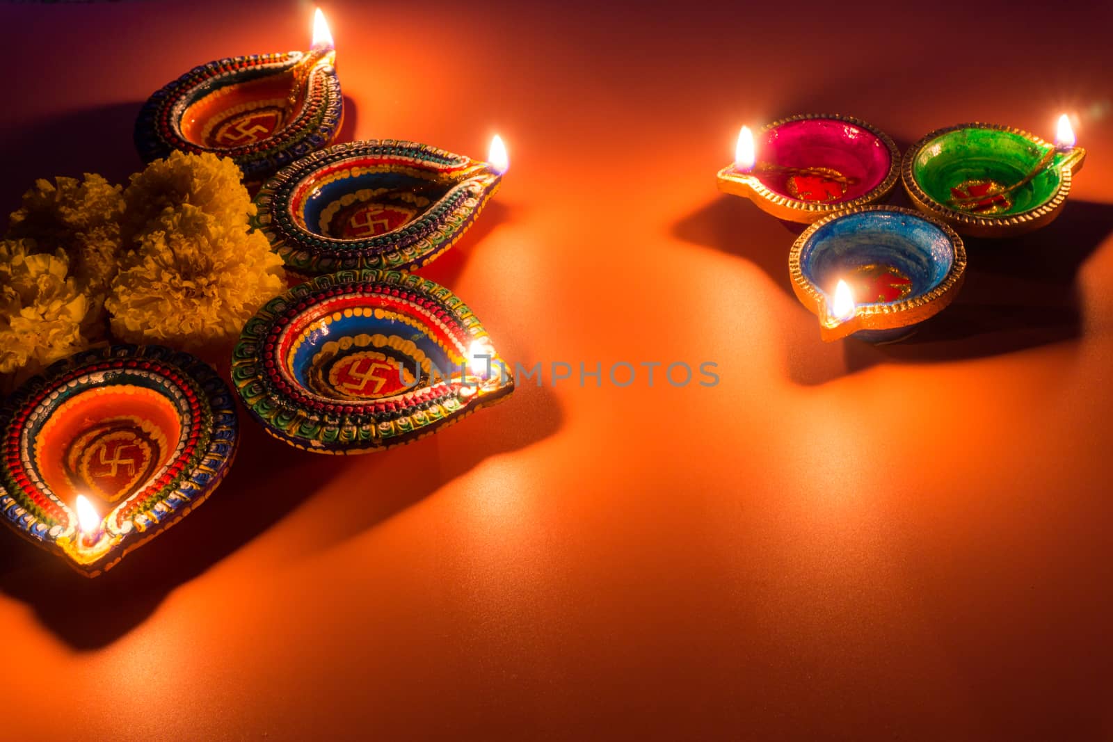 Indian festival Diwali, Diya oil lamps lit on colorful rangoli. Hindu traditional. Happy Deepavali. Copy space for text.