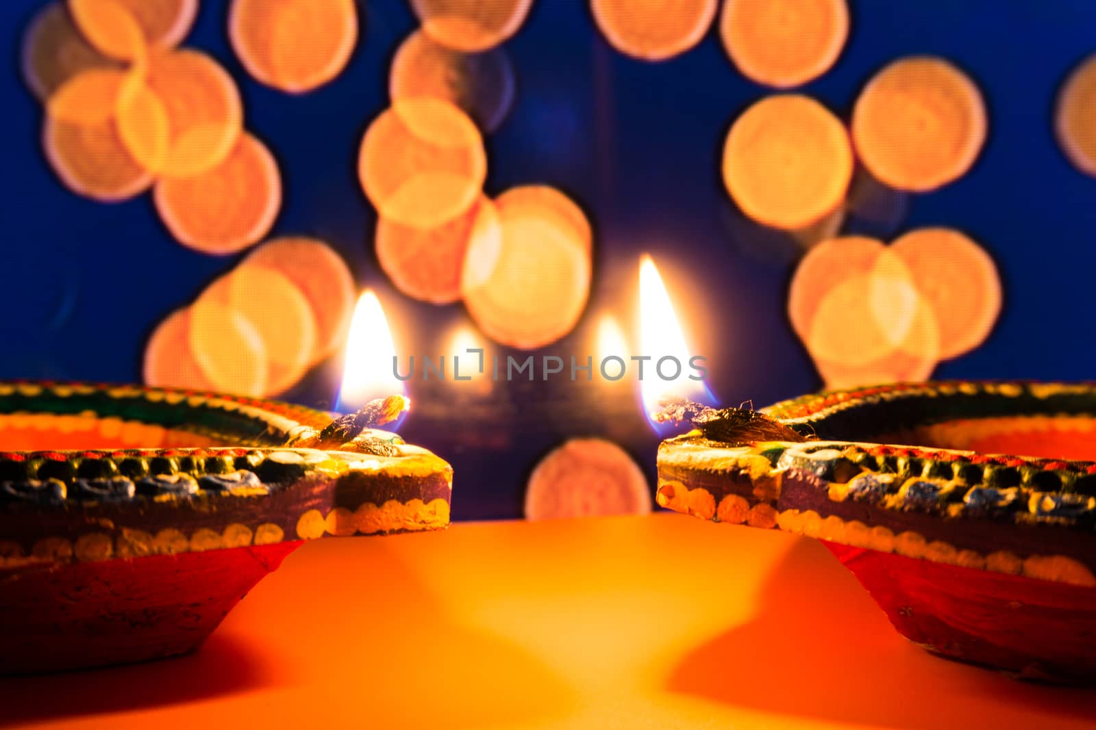 Indian festival Diwali, Diya oil lamps lit on colorful rangoli. Hindu traditional. Happy Deepavali. Copy space for text.