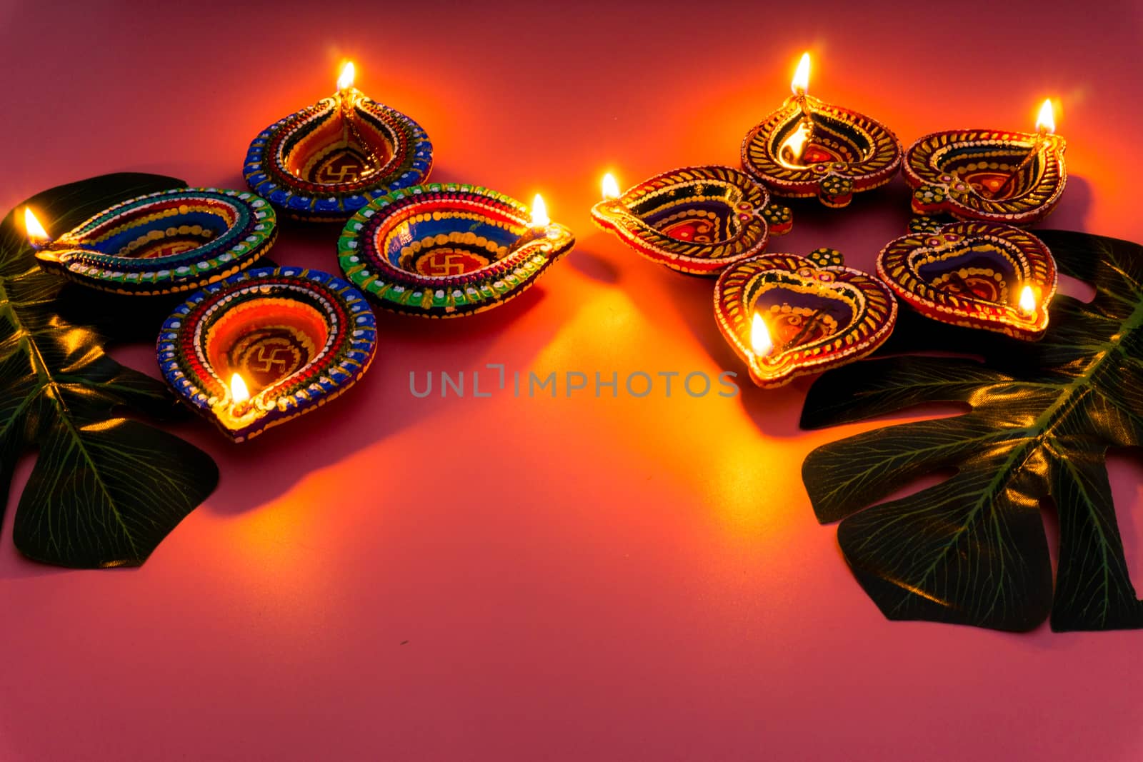 Indian festival Diwali, Diya oil lamps lit on colorful rangoli. Hindu traditional. Happy Deepavali. Copy space for text.