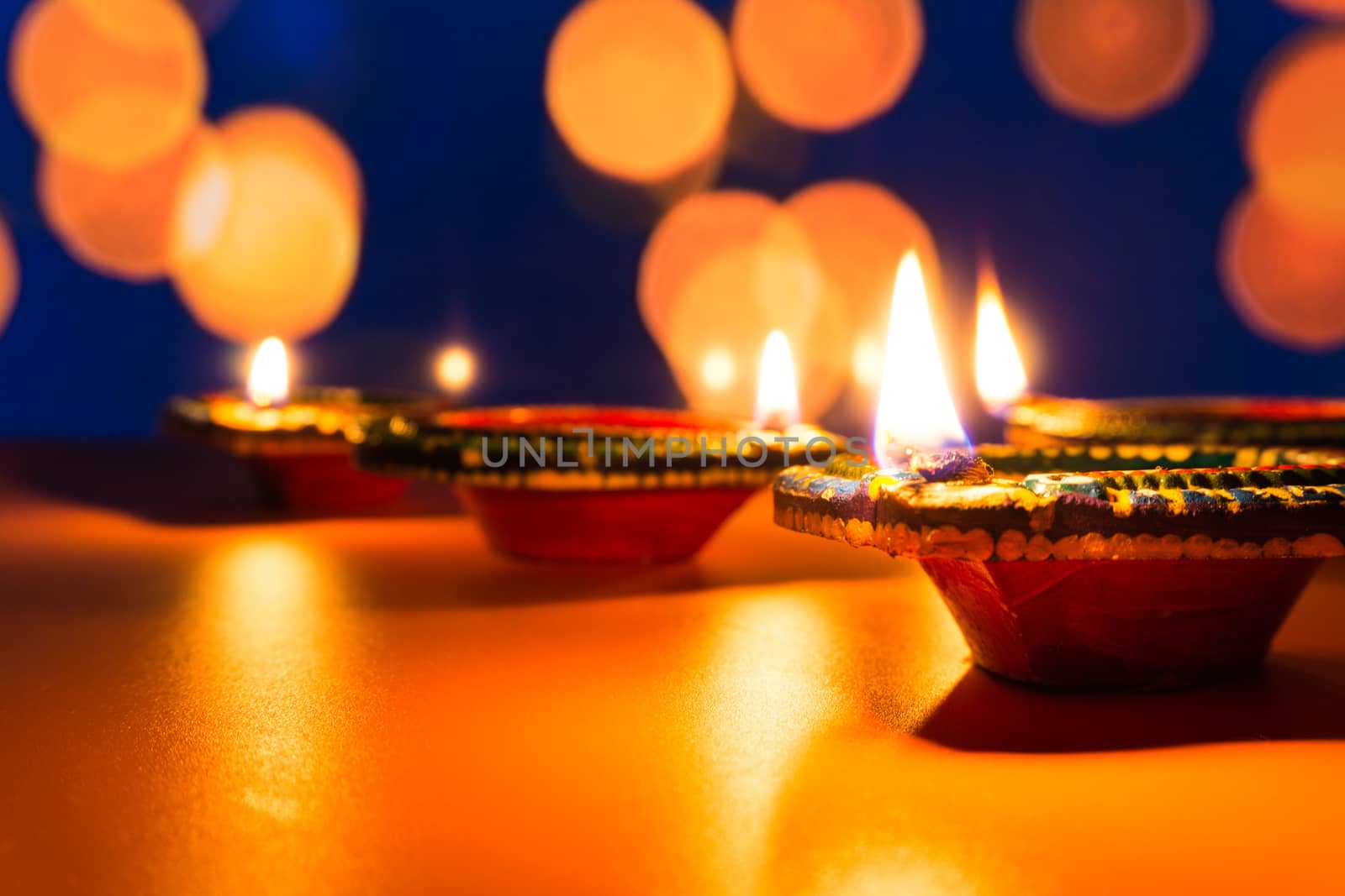 Indian festival Diwali, Diya oil lamps lit on colorful rangoli. Hindu traditional. Happy Deepavali. Copy space for text.