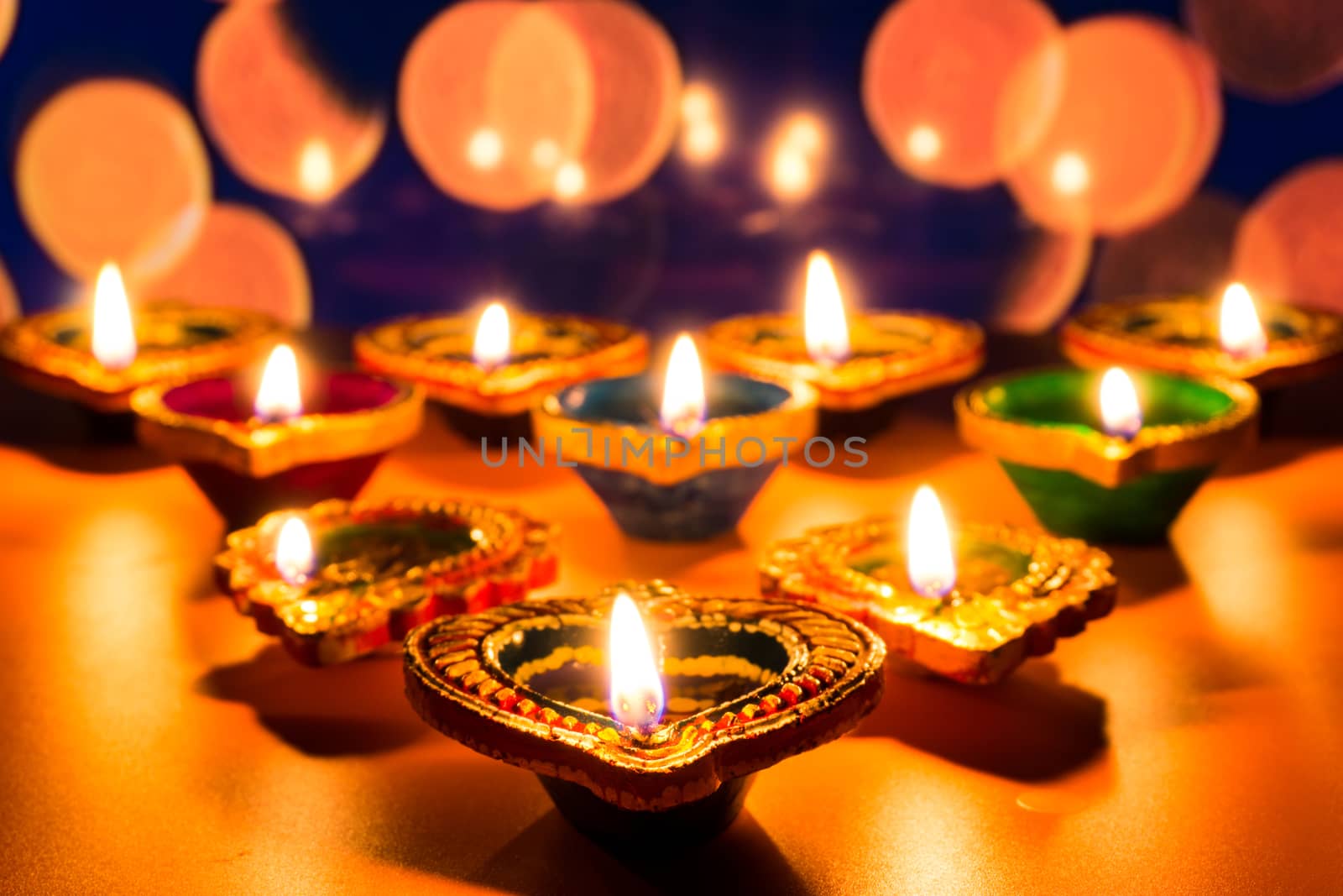 Indian festival Diwali, Diya oil lamps lit on colorful rangoli. Hindu traditional. Happy Deepavali. Copy space for text.