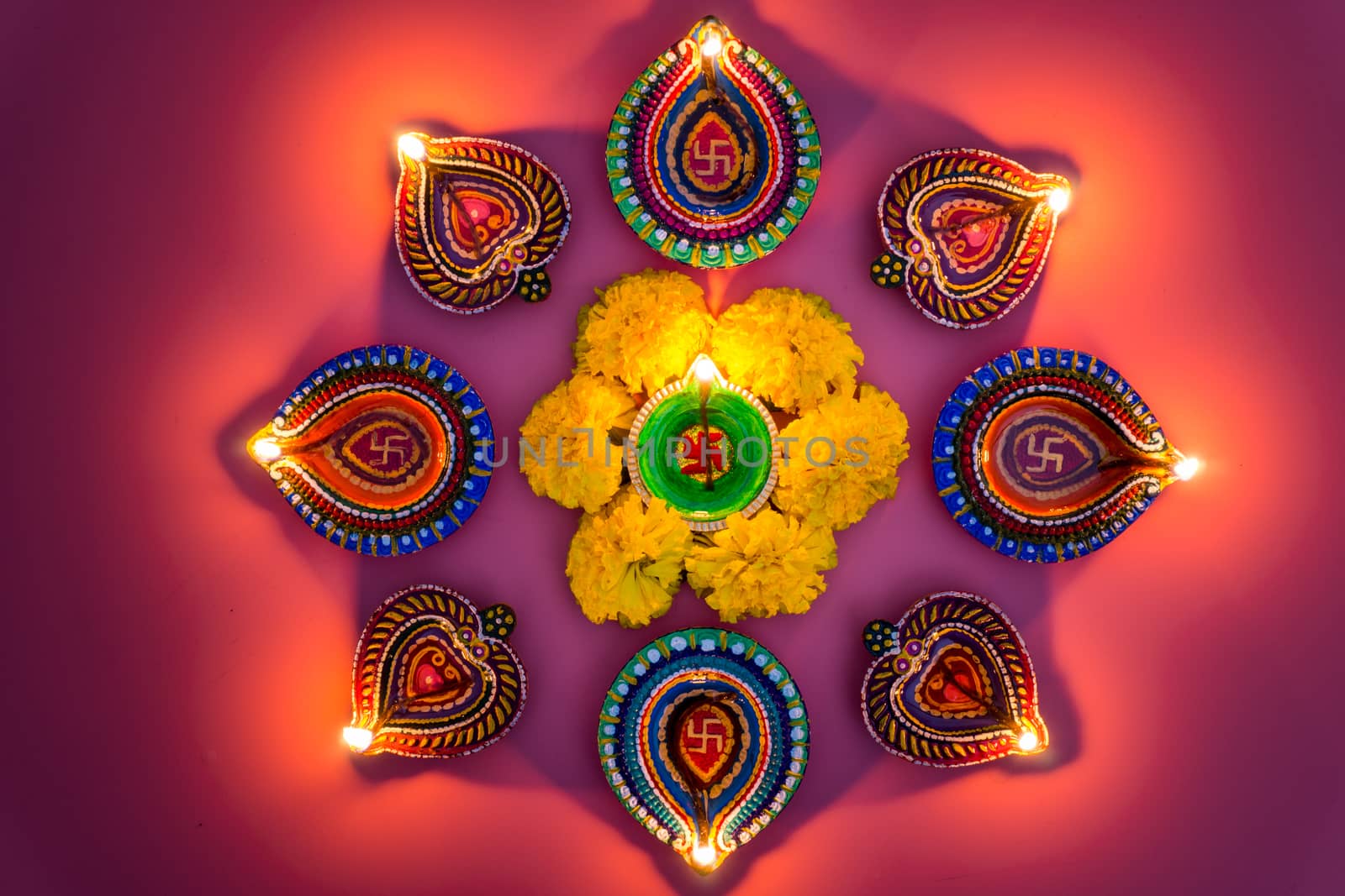 Indian festival Diwali, Diya oil lamps lit on colorful rangoli. Hindu traditional. Happy Deepavali. Copy space for text.