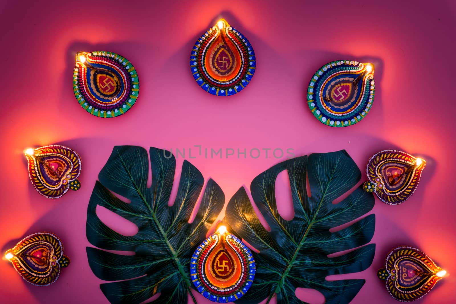 Indian festival Diwali, Diya oil lamps lit on colorful rangoli. Hindu traditional. Happy Deepavali. Copy space for text.
