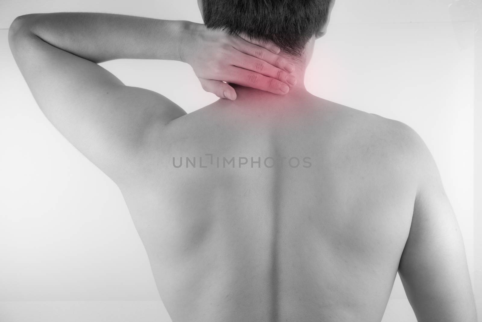 A man feeling exhausted and suffering from neck and shoulder pain and injury on white background. Healthcare and medical concept.