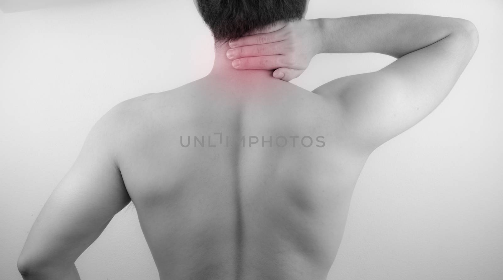 A man feeling exhausted and suffering from neck and shoulder pain and injury on white background. Healthcare and medical concept.