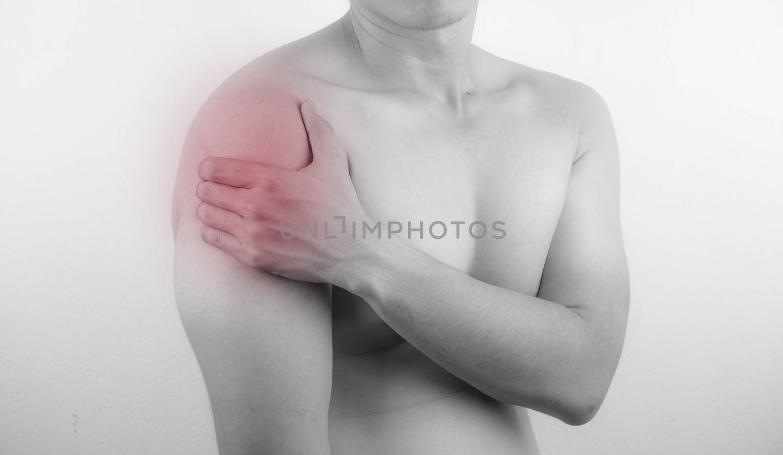 A man feeling exhausted and suffering from neck and shoulder pain and injury on white background. Healthcare and medical concept.