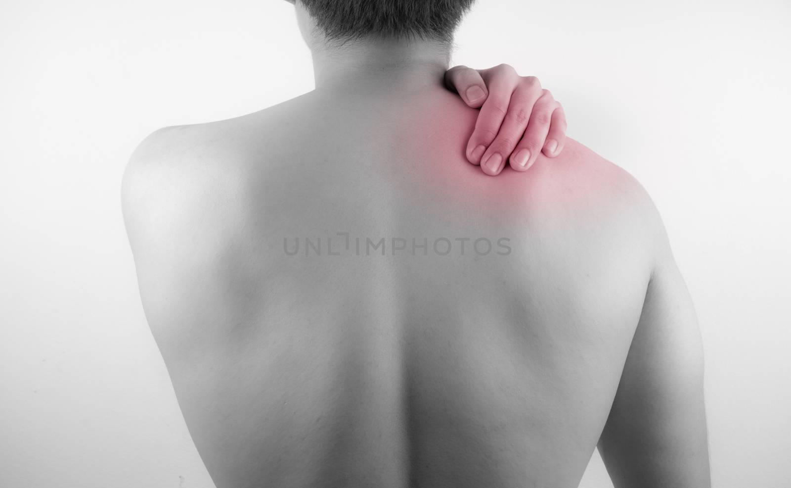 A man feeling exhausted and suffering from neck and shoulder pain and injury on white background. Healthcare and medical concept.