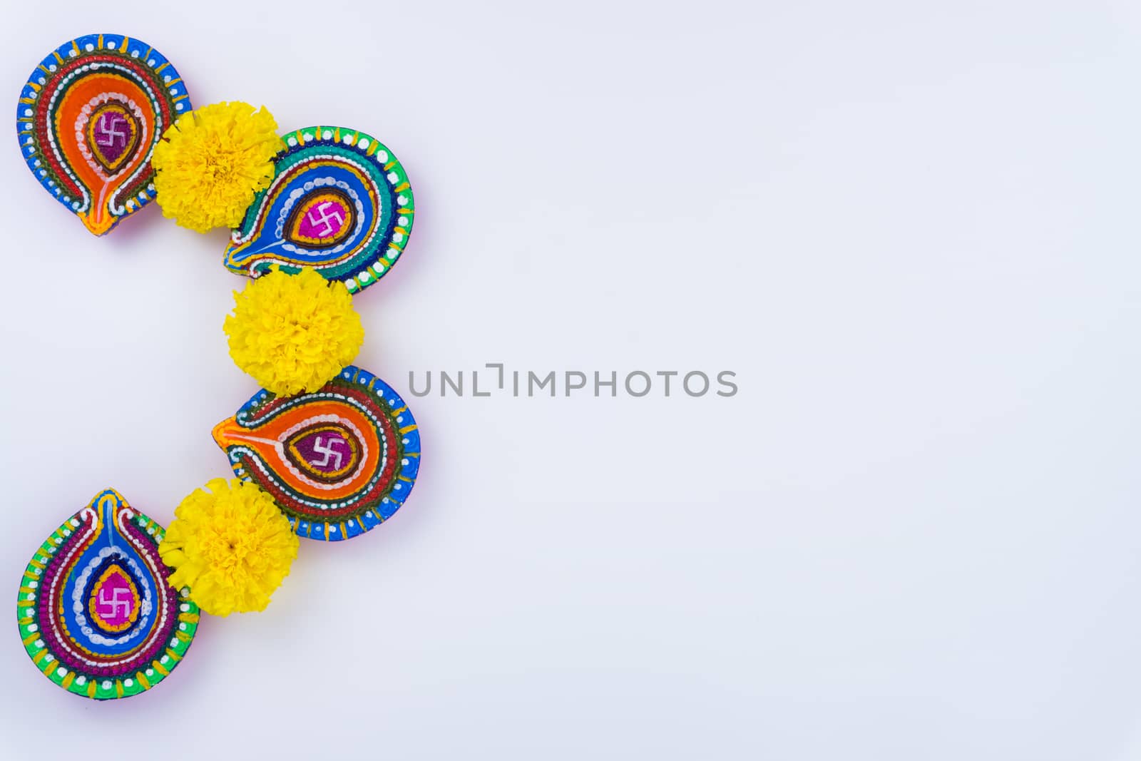 Indian festival Diwali, Diya oil lamps lit on colorful rangoli. Hindu traditional. Happy Deepavali. Copy space for text.