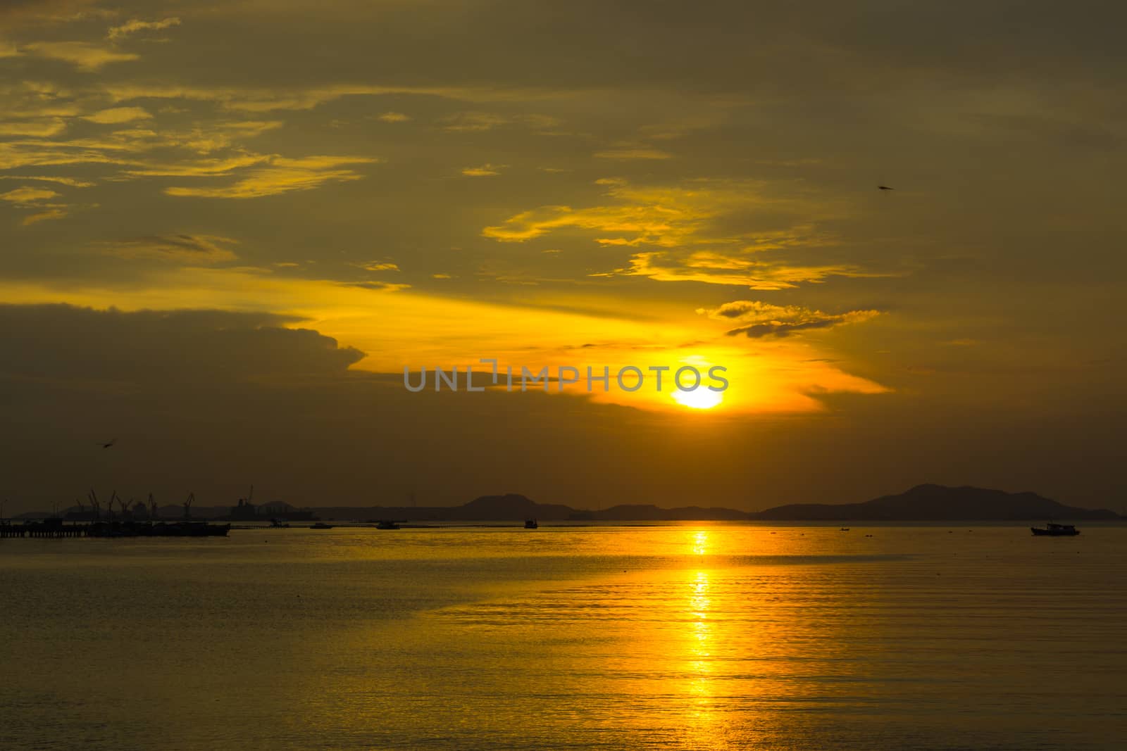 sunset over the ocean with dramatic cloudscape.