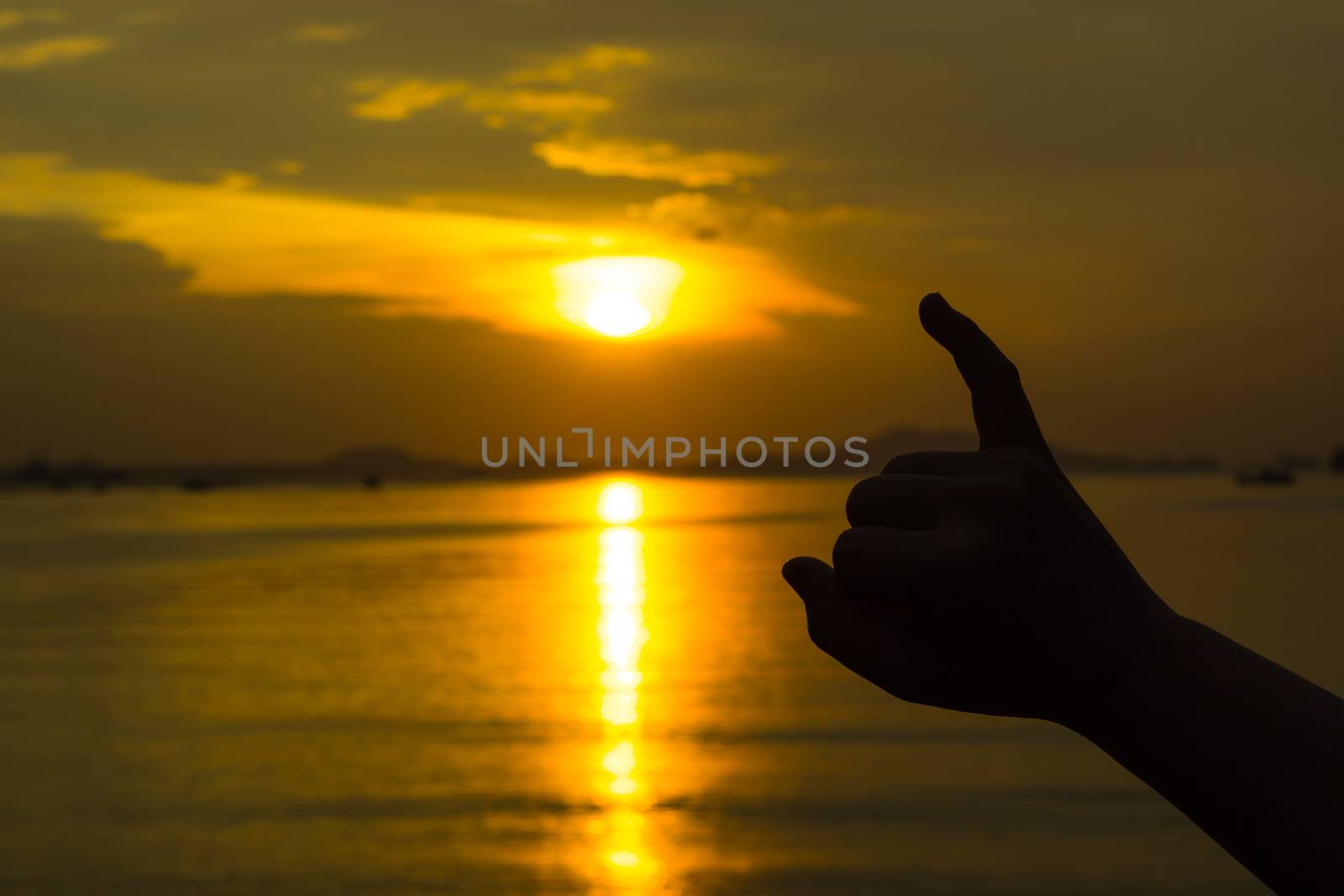 Silhouette of hand to pinky promise, pinky swear in front of the by mikesaran