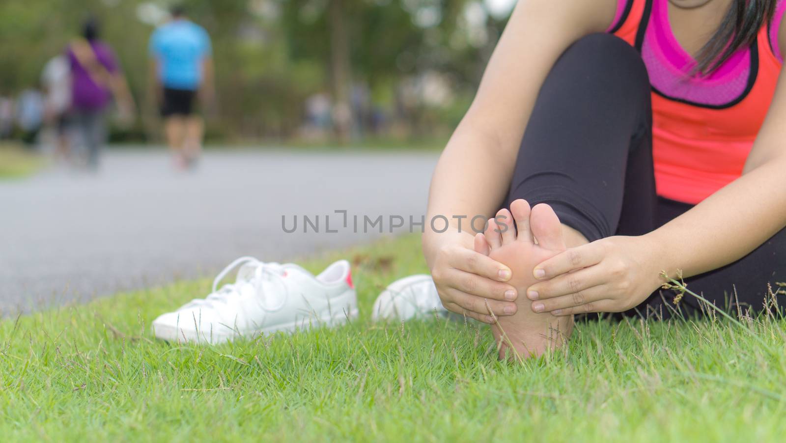 Ankle sprained. Young woman suffering from an ankle injury while by mikesaran