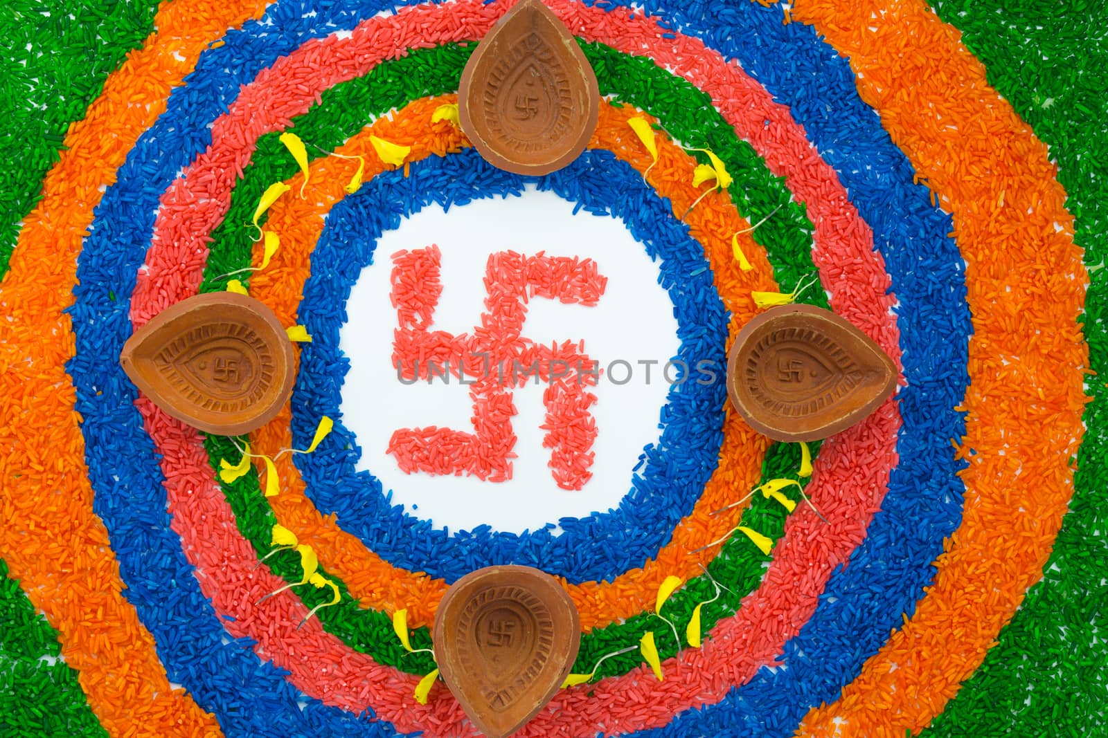 Indian festival Diwali, Diya oil lamps lit on colorful rangoli with Swastika symbol. Hindu traditional. Happy Deepavali.