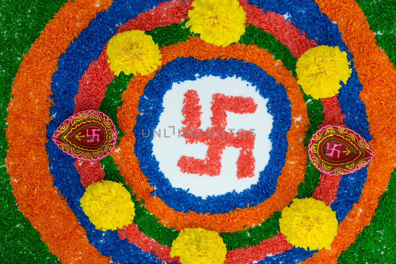 Indian festival Diwali, Diya oil lamps lit on colorful rangoli with Swastika symbol. Hindu traditional. Happy Deepavali.