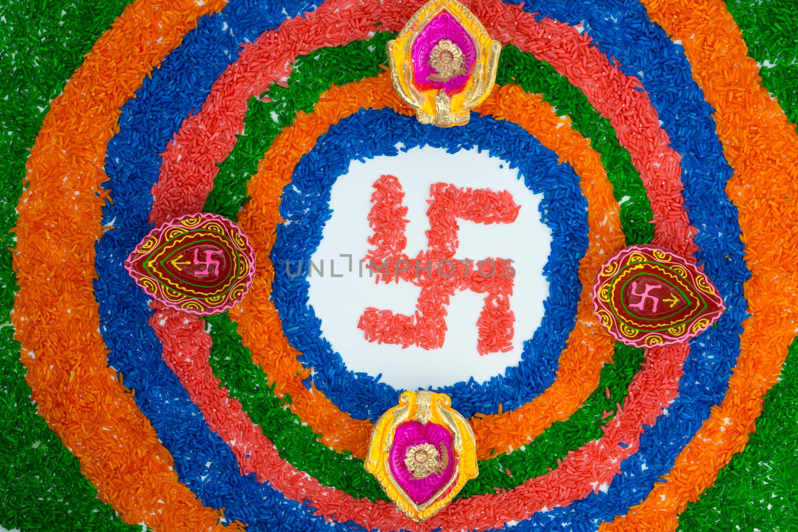 Indian festival Diwali, Diya oil lamps lit on colorful rangoli with Swastika symbol. Hindu traditional. Happy Deepavali.