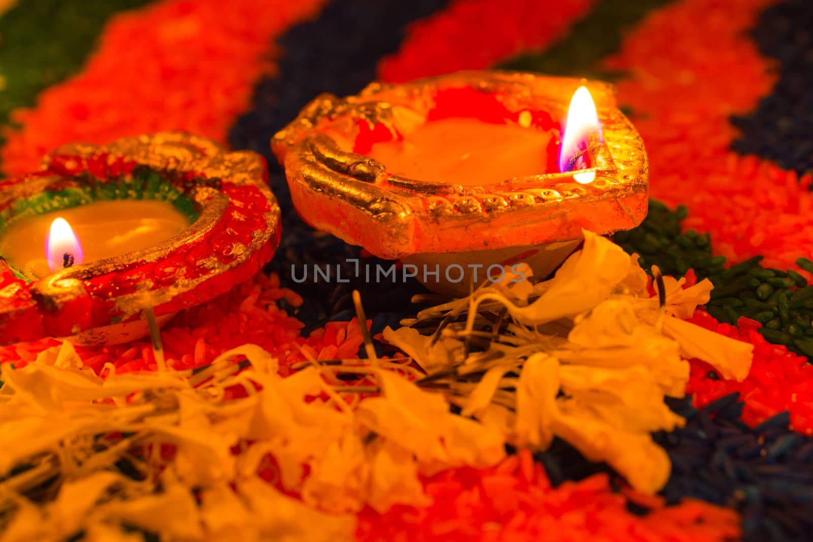 Indian festival Diwali, Diya oil lamps lit on colorful rangoli with Swastika symbol. Hindu traditional. Happy Deepavali.