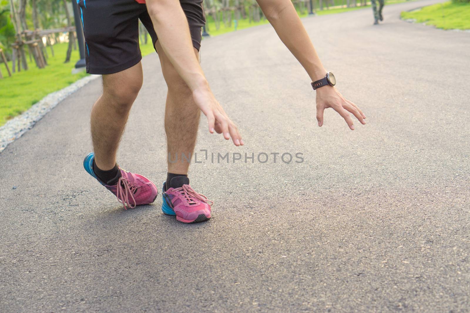 Sport man ankle sprain while running at the park.  Healthcare and sport concept.