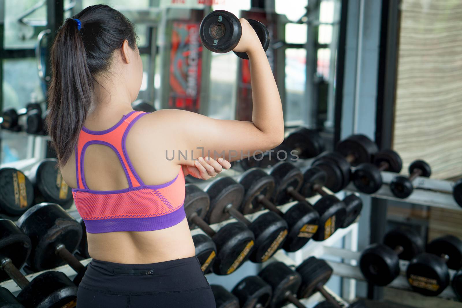 Woman hand holding excessive fat arm. Pinching arm fat flabby skin. Weight loss, slim body, healthy lifestyle concept.