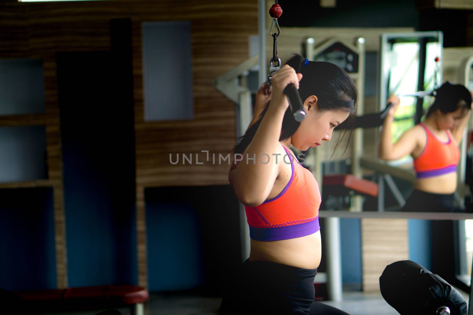 Asian beauty woman doing exercise for back. Working out on a lat by mikesaran