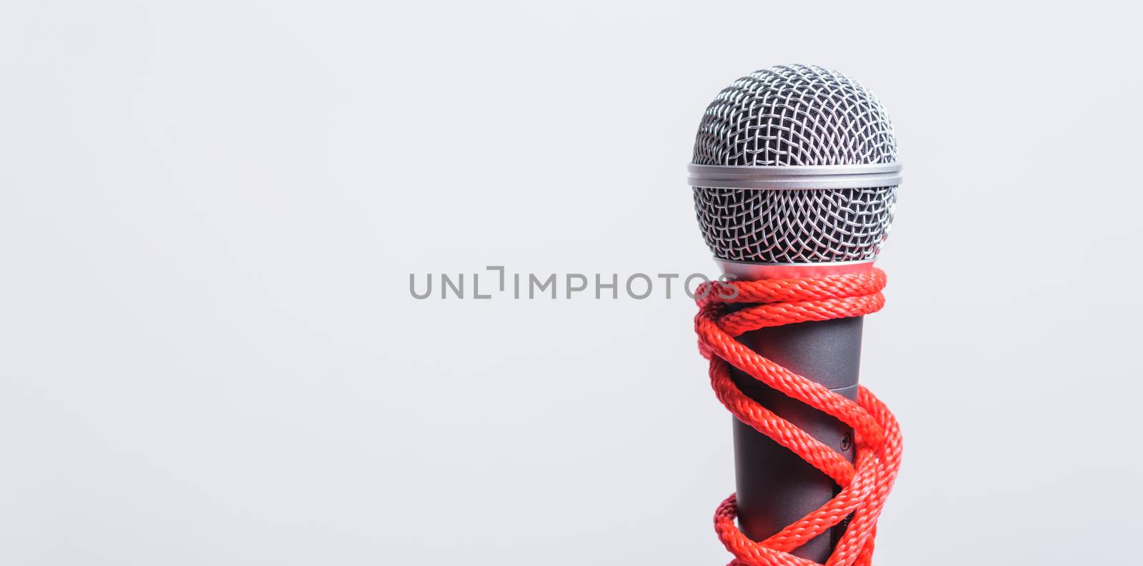 Rope on microphone with copy space on white background by Sorapop
